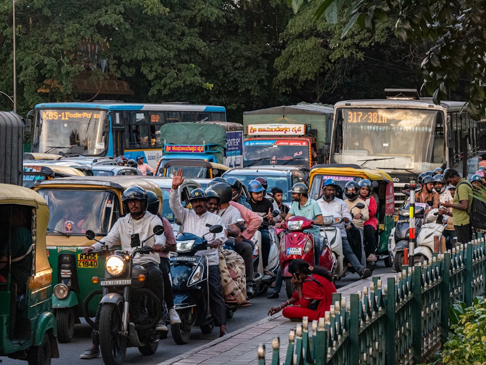 a group of people riding scooters down a street