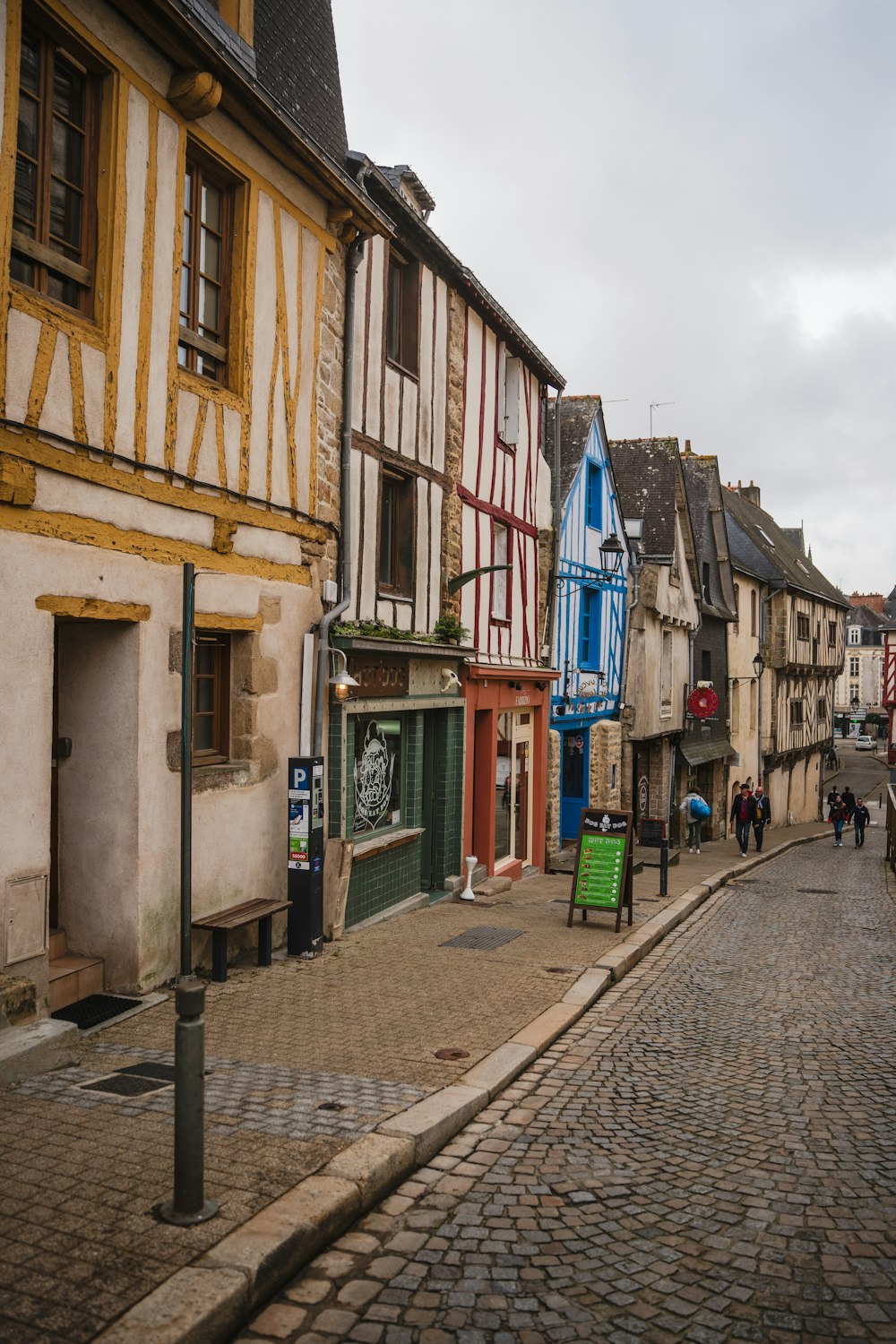 a cobblestone street lined with old buildings