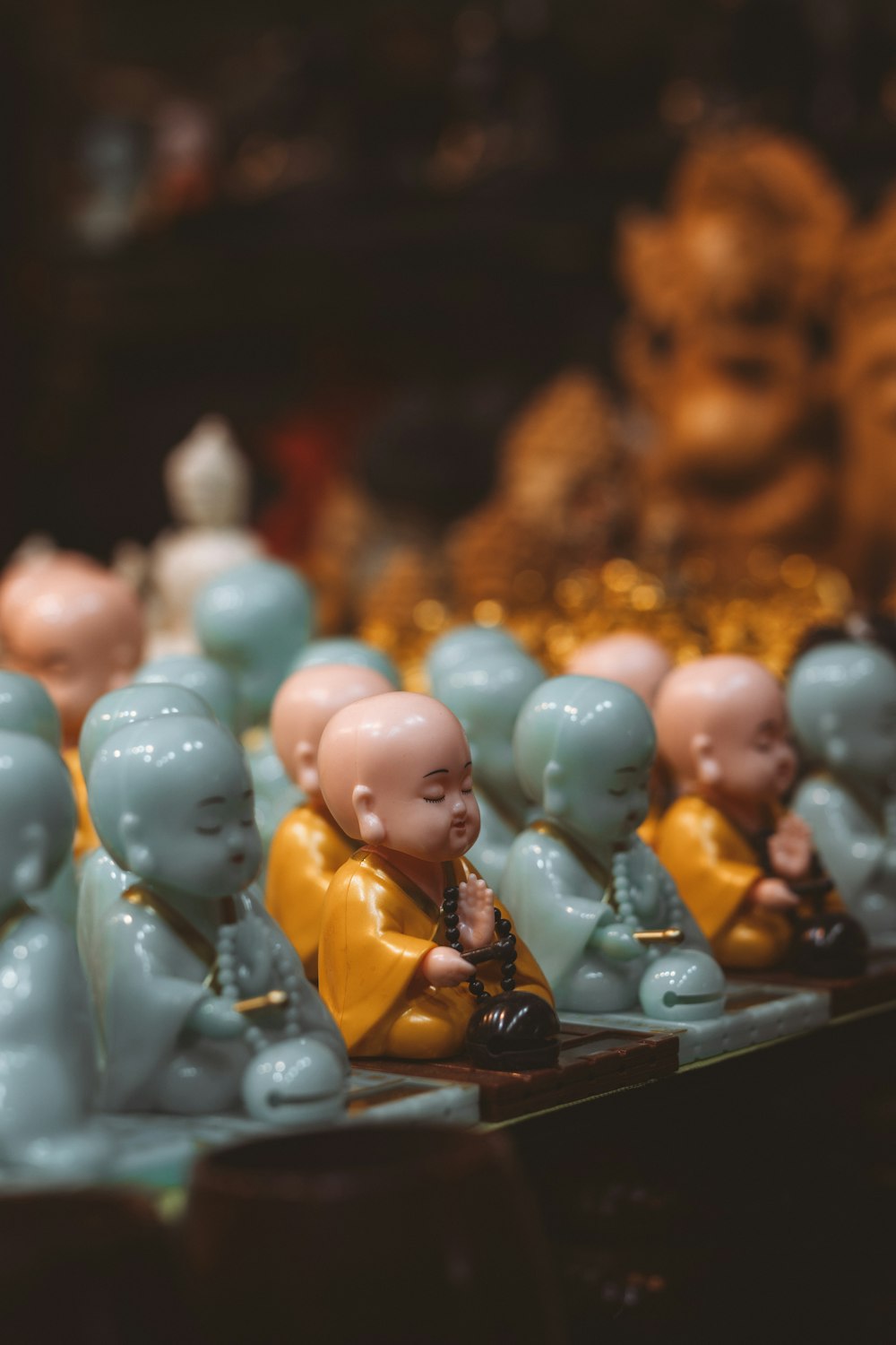a row of small buddha figurines sitting next to each other