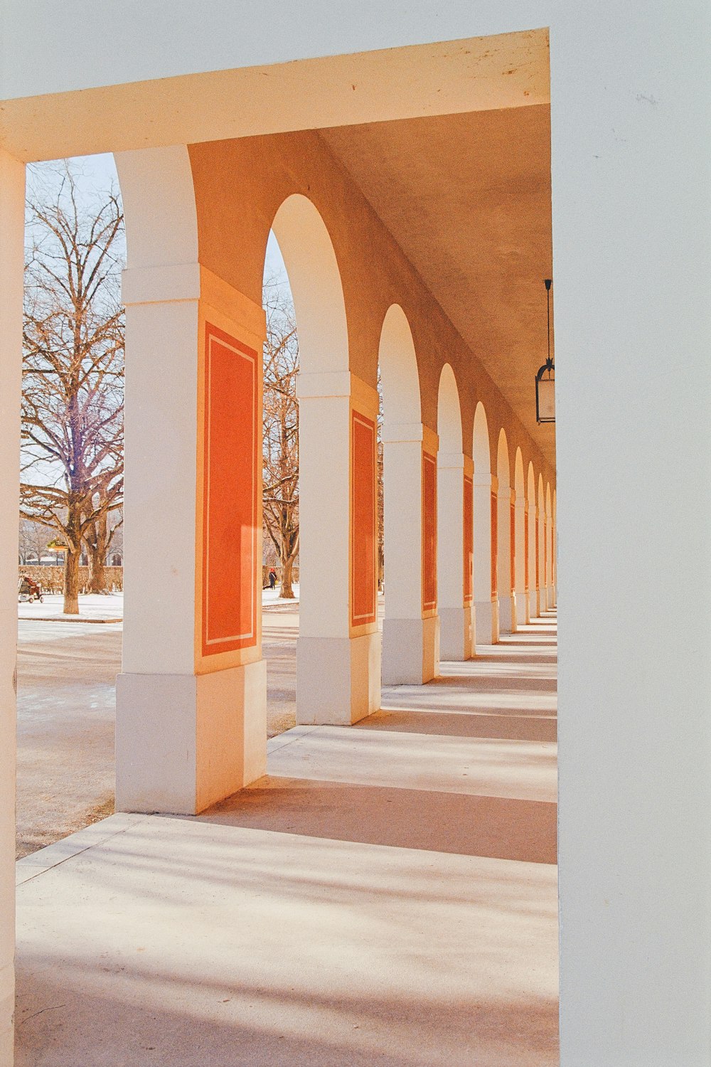 a row of white pillars with orange doors