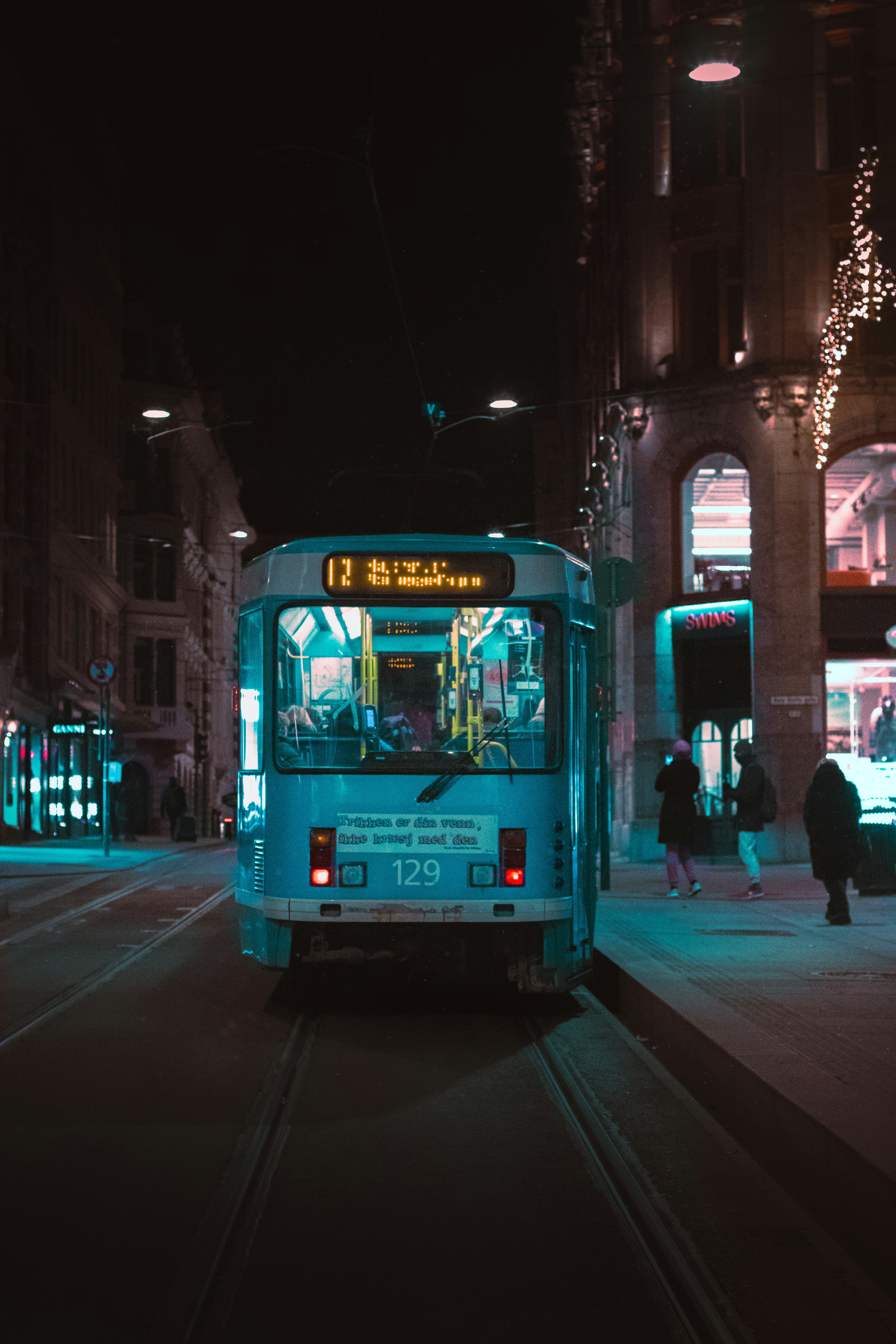 a bus driving down a street at night