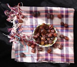 a bowl of dates sitting on top of a checkered cloth