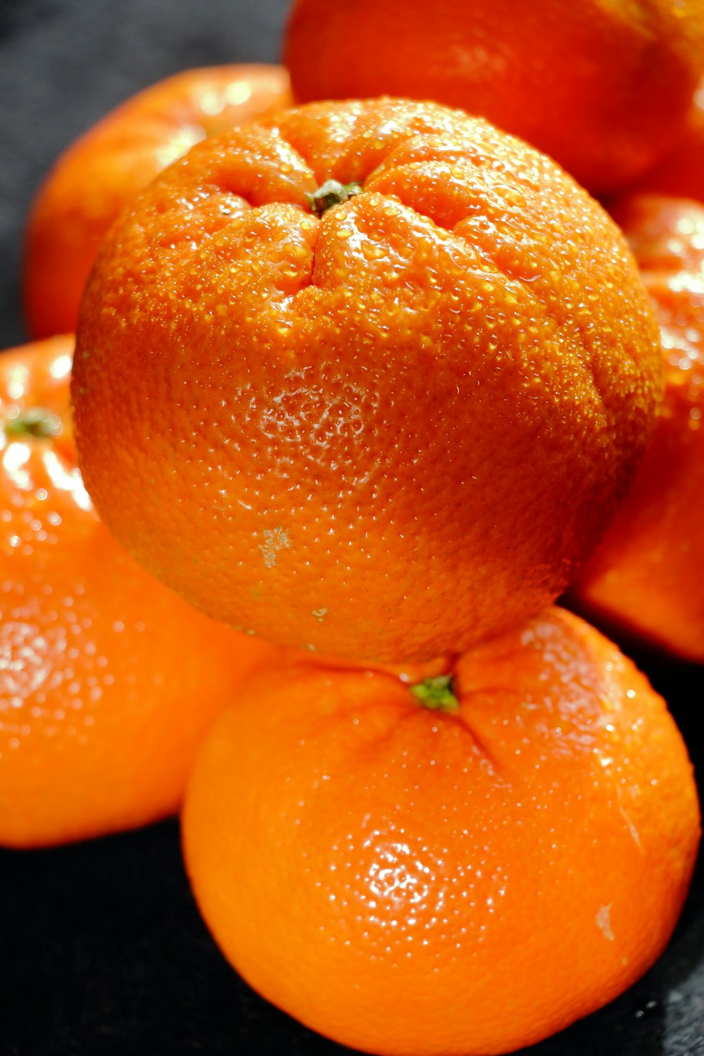 a pile of oranges sitting on top of a table