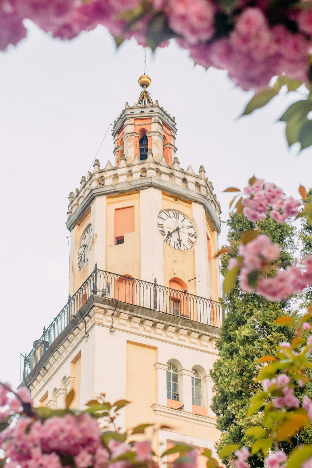 a tall clock tower with a clock on each of it's sides