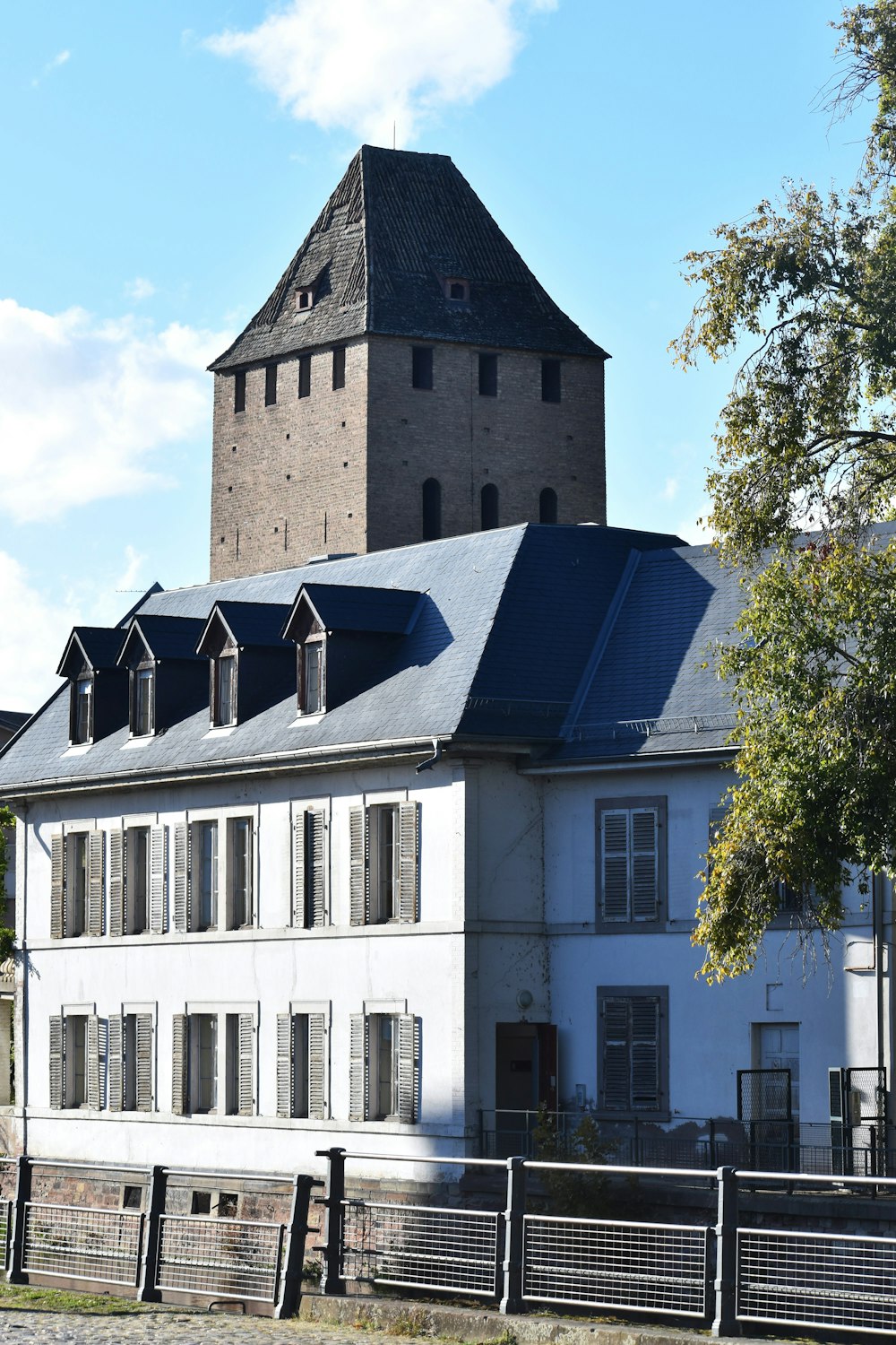 a large white building with a clock tower in the background