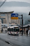 a bus driving down a street next to a tall building