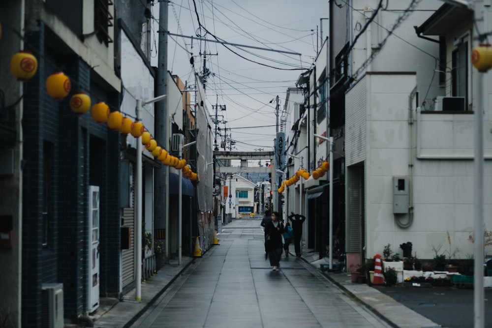 a couple of people that are walking down a street