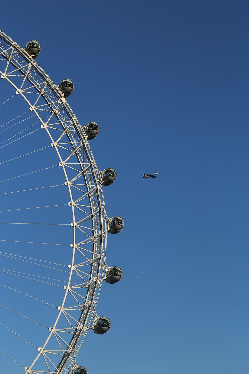 a large ferris wheel sitting next to a blue sky