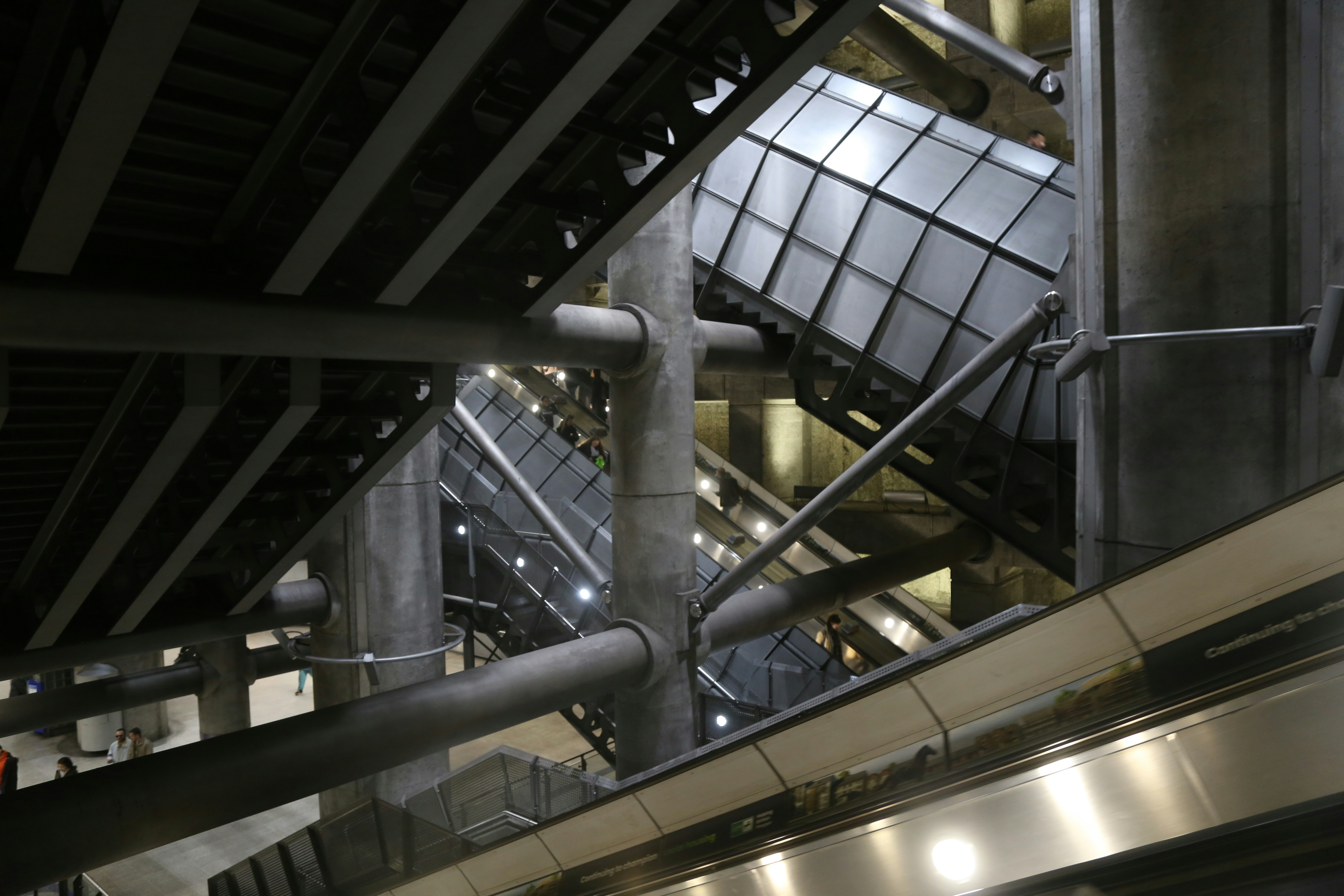 an escalator in a building with metal railings