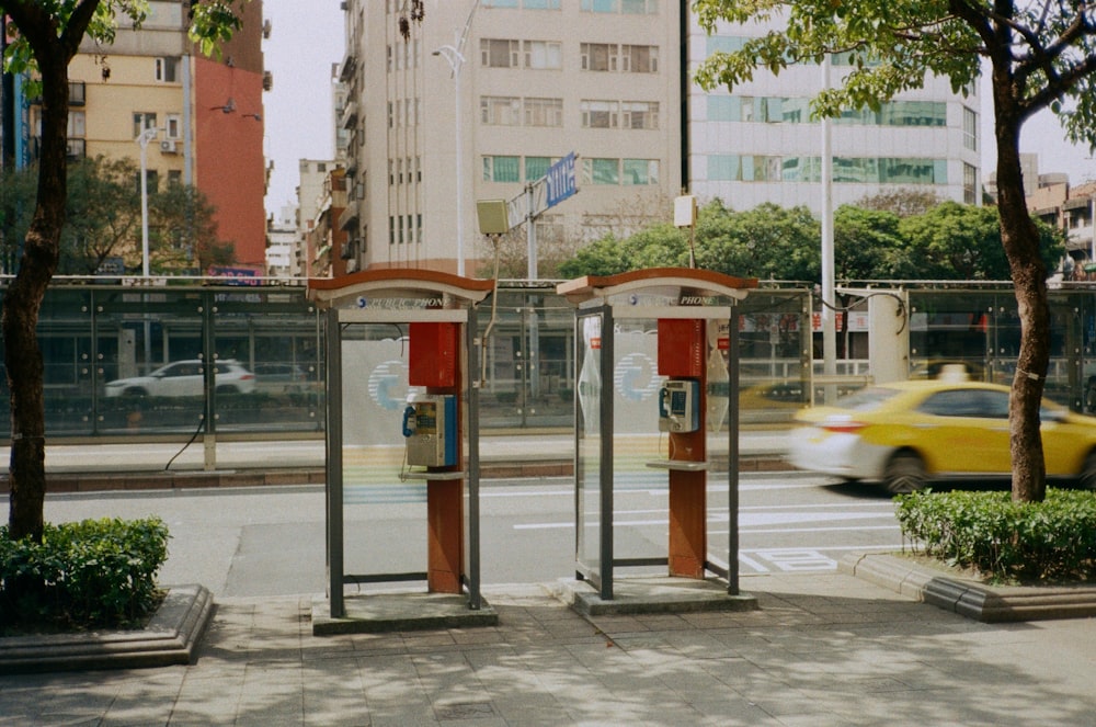 a couple of parking meters sitting on the side of a road