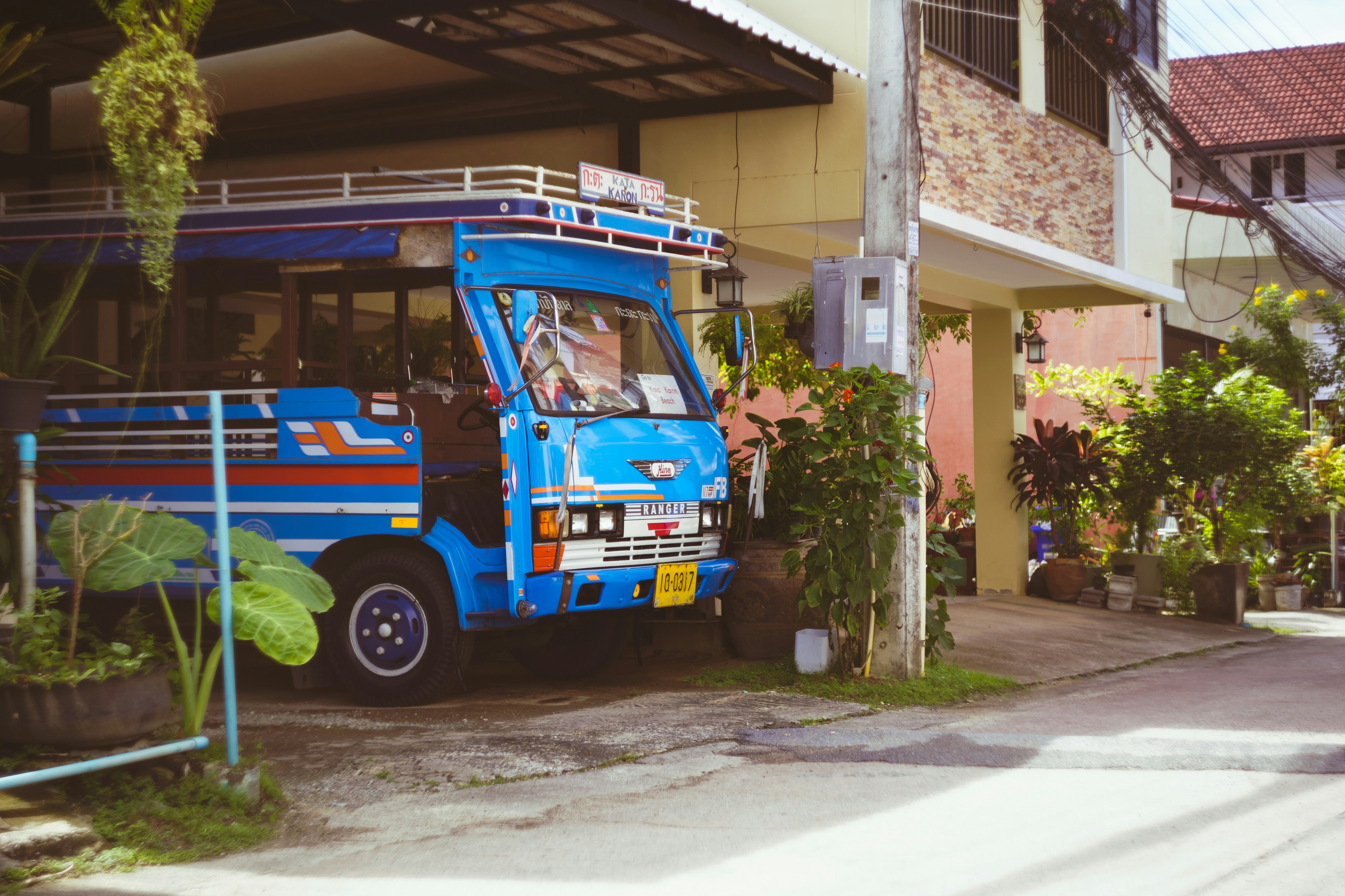a blue truck parked in front of a building