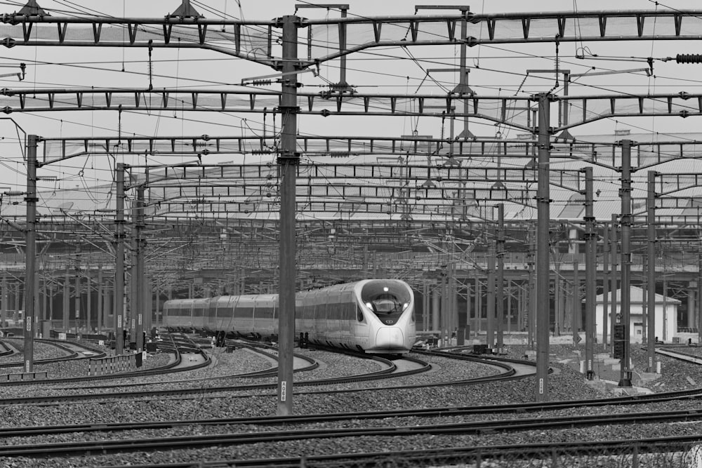 a black and white photo of a train on the tracks