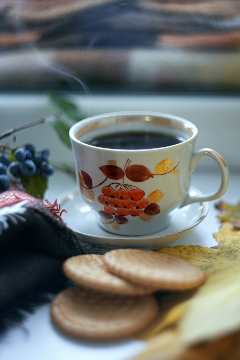 a cup of coffee and some cookies on a table