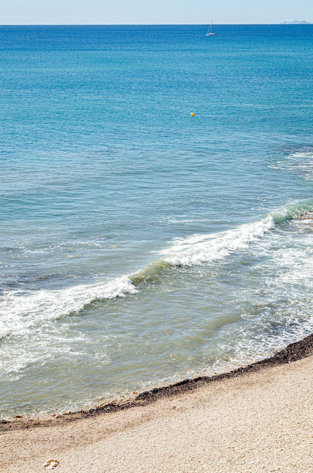 a person riding a surfboard on a wave covered beach