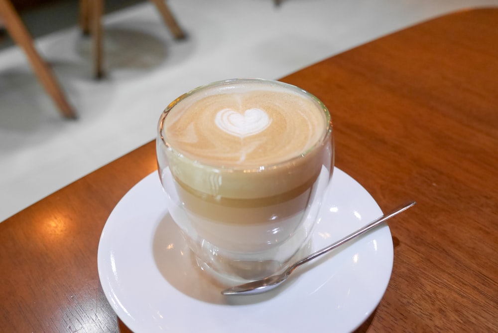 a cappuccino on a saucer with a spoon