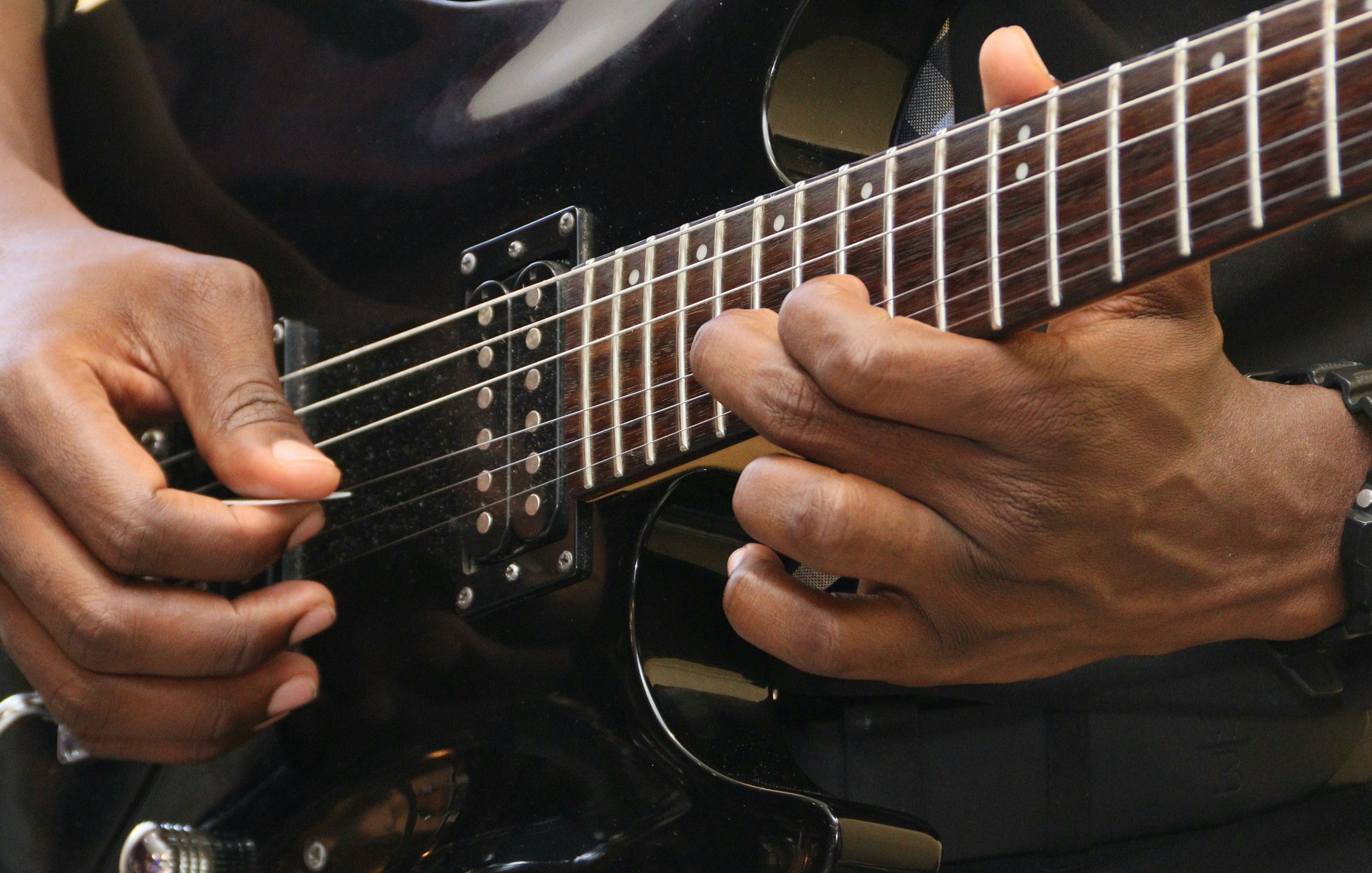 a close up of a person playing a guitar