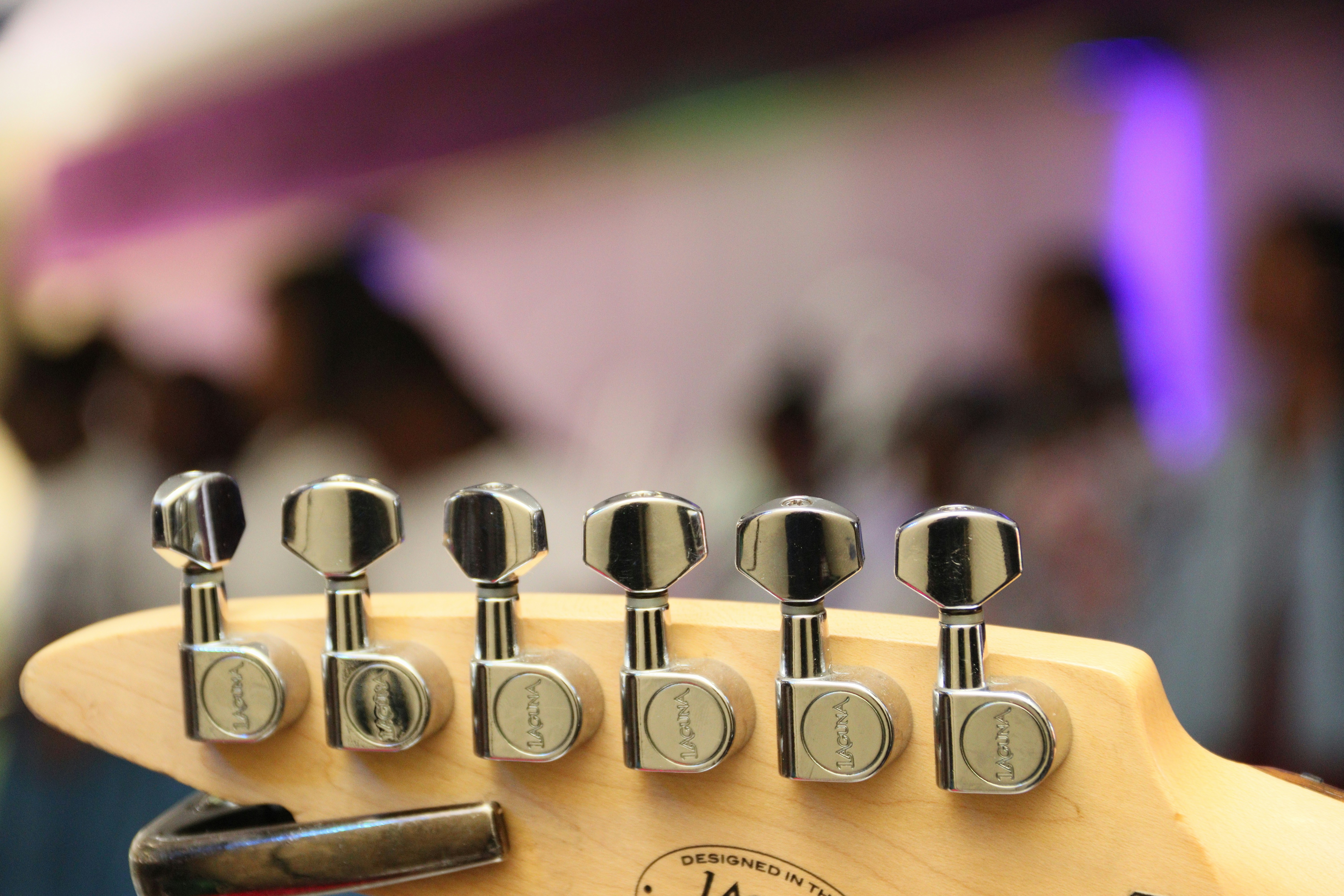 a close up of a guitar with a bunch of knobs on it