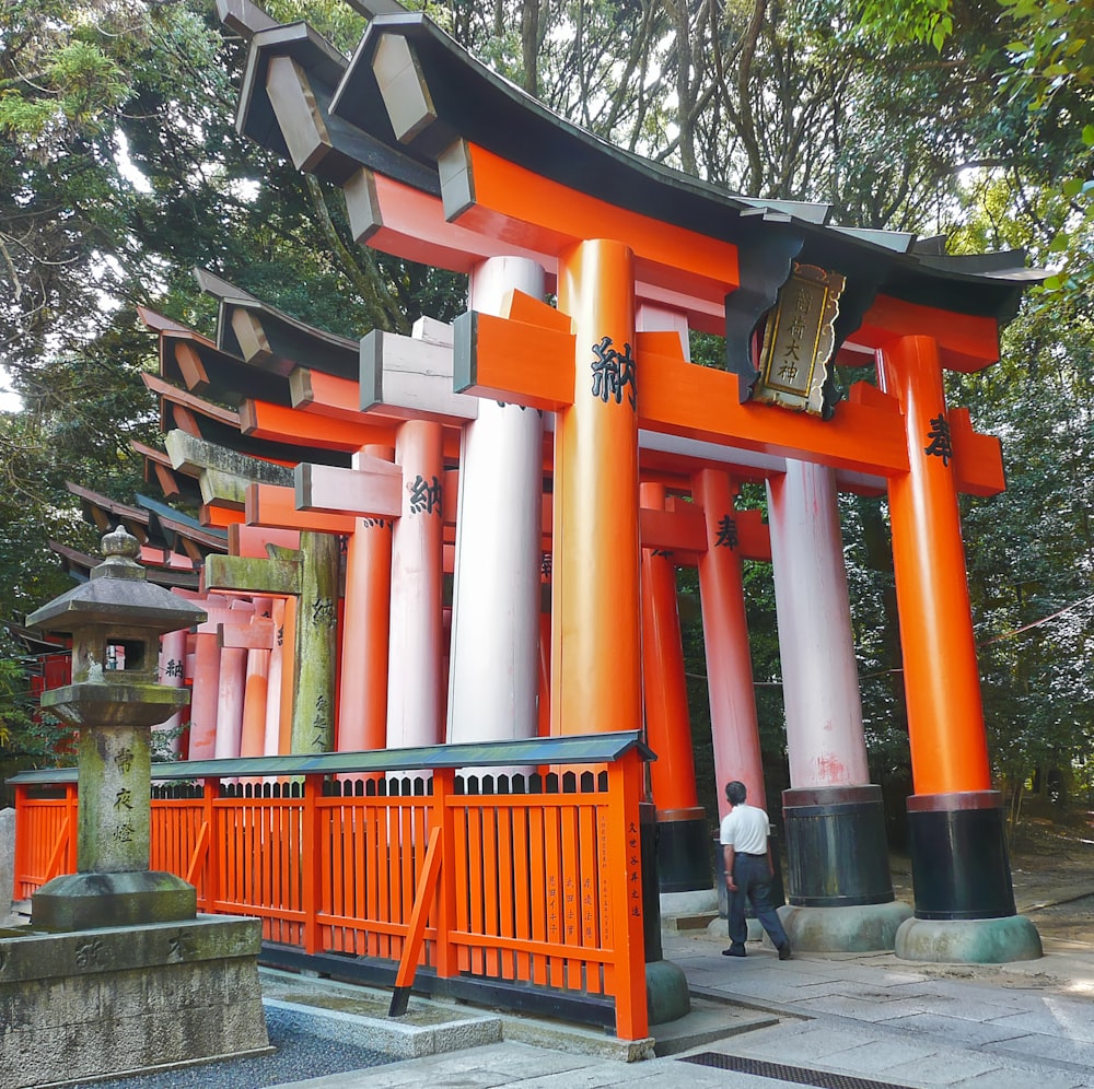 a man standing in front of a tall orange structure