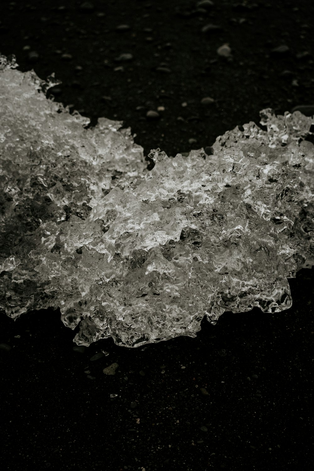 a black and white photo of ice on the ground