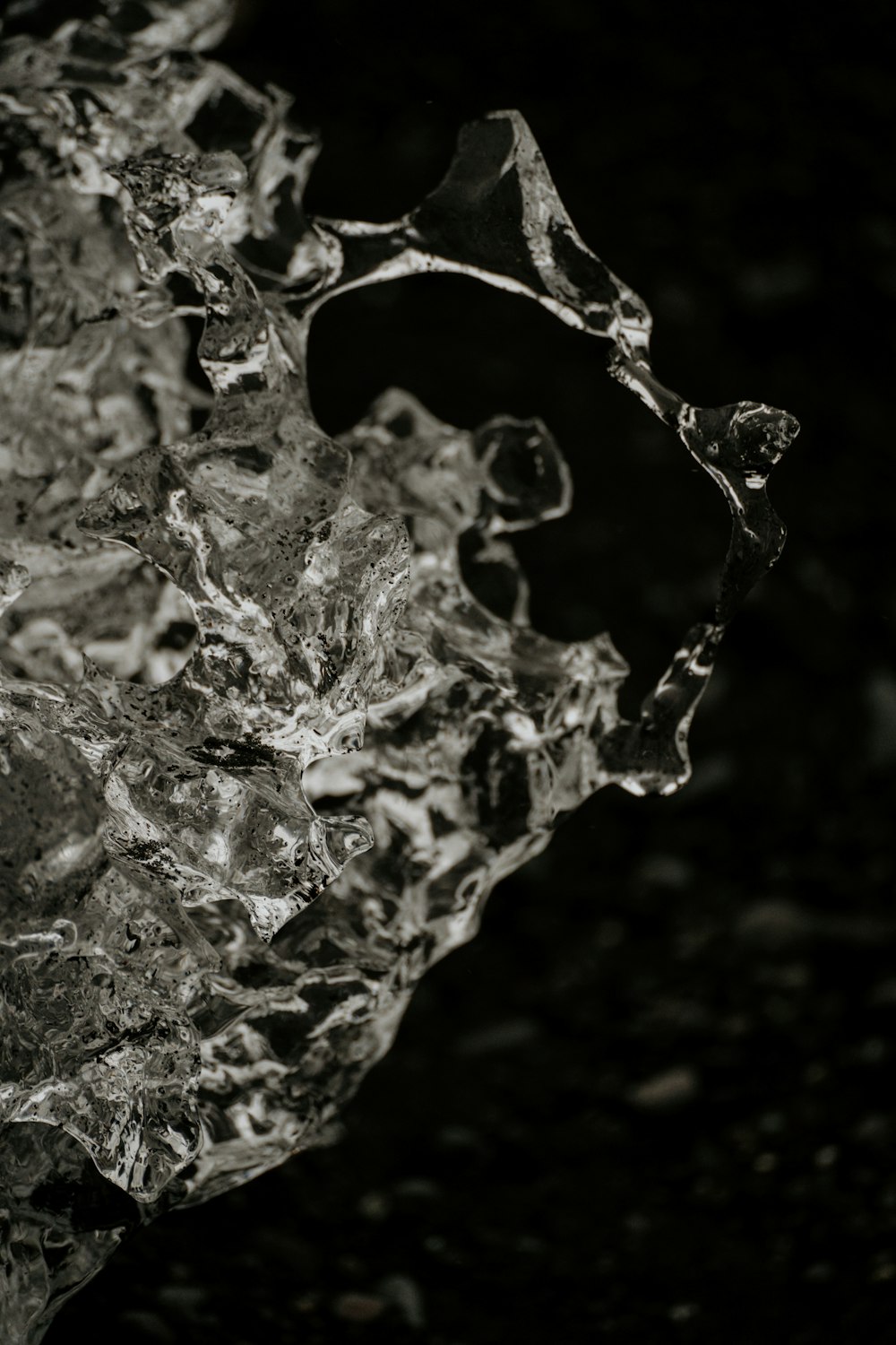 a black and white photo of a piece of ice