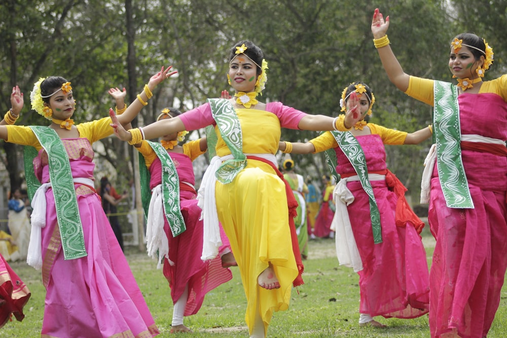 a group of women dancing in a park