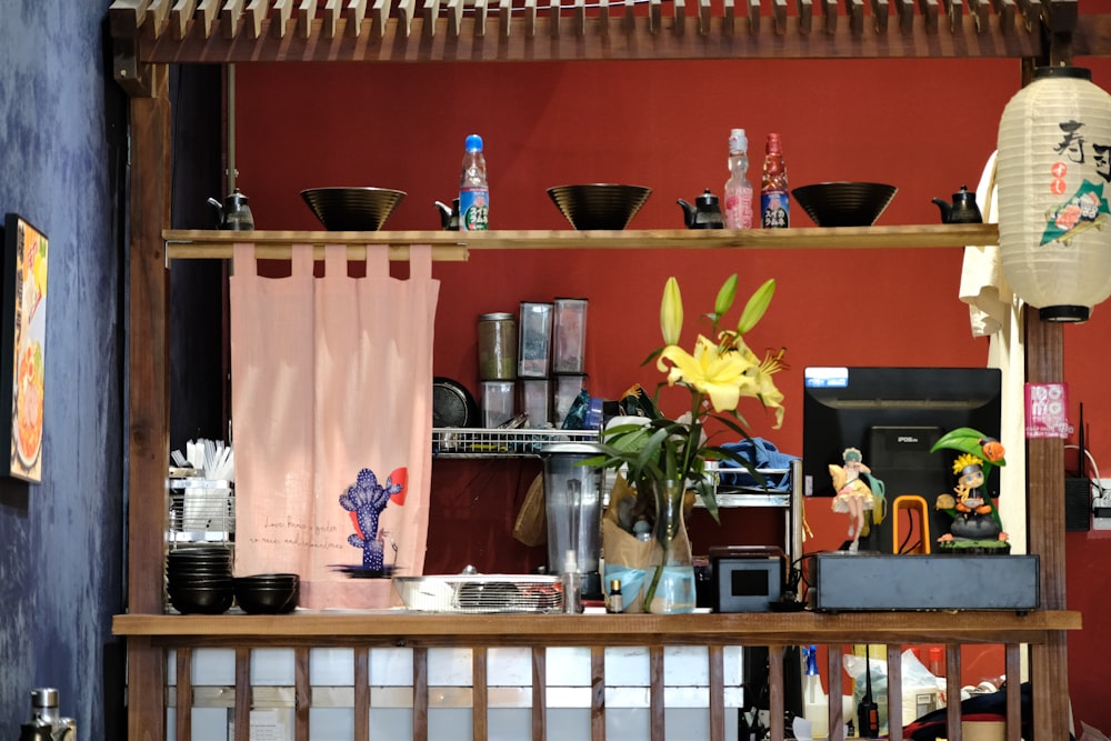 a shelf with a vase of flowers on top of it