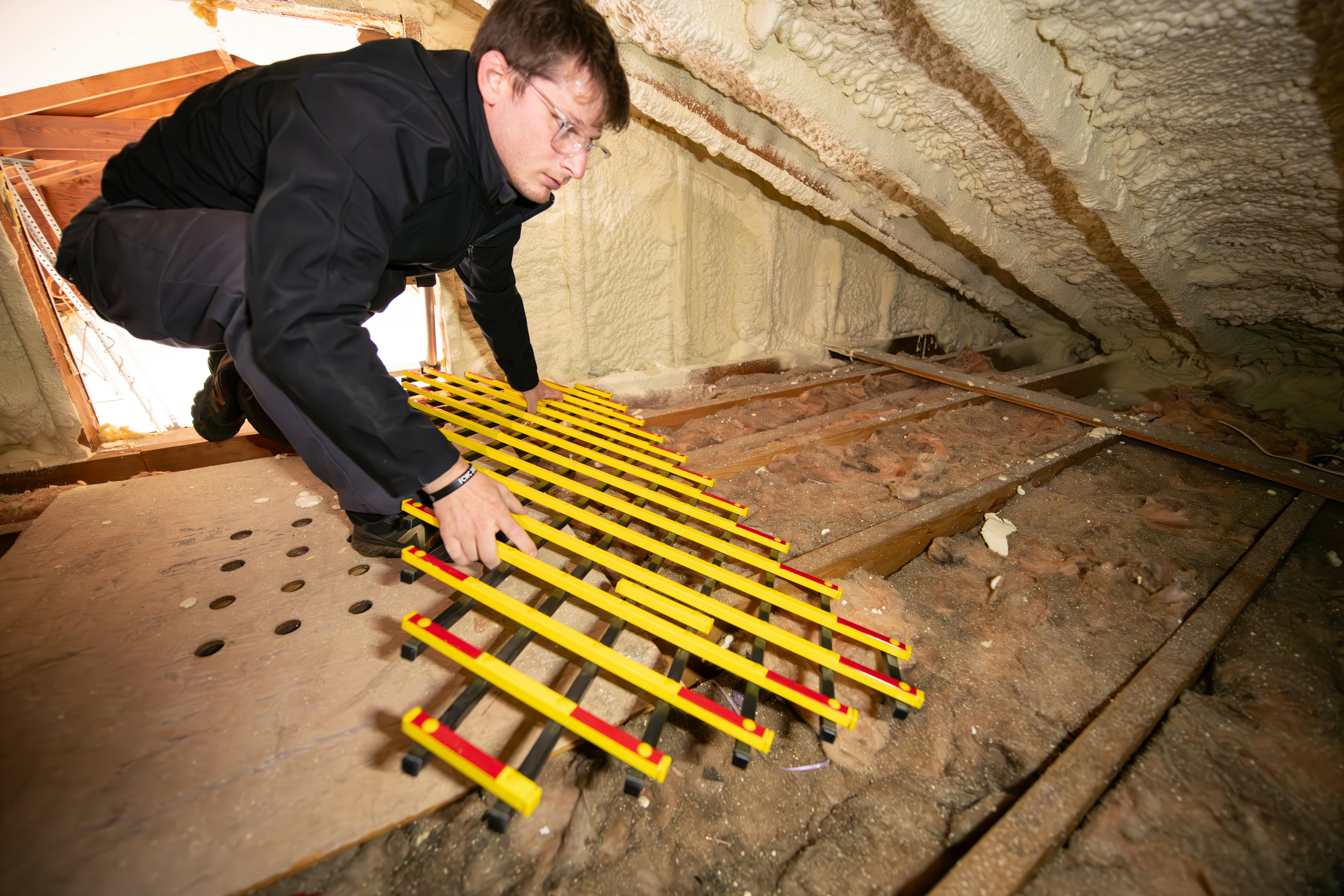 technician working on ductwork in an attic or basement - air purifier installation carson, ca