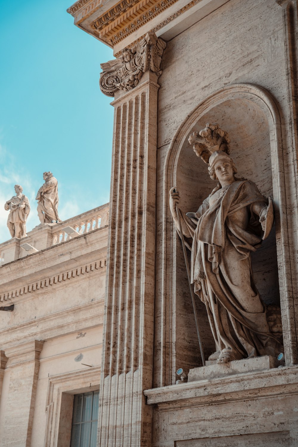 a statue of a woman with a crown on top of a building