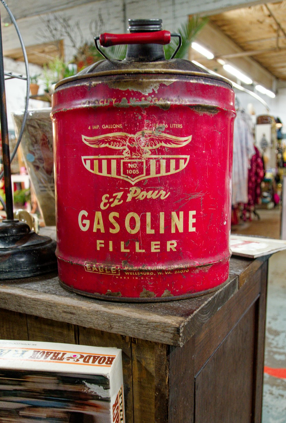 a red gas can sitting on top of a wooden table