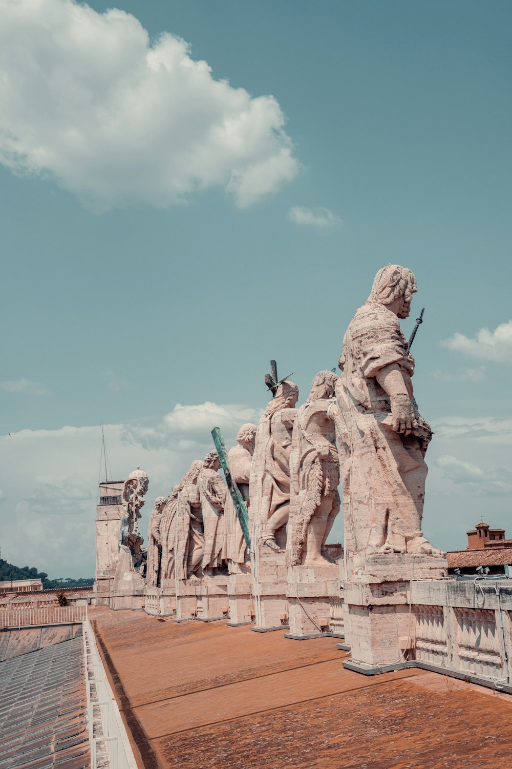 a group of statues sitting on top of a roof