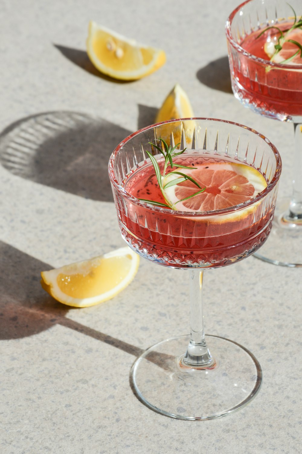 a close up of two wine glasses filled with a drink