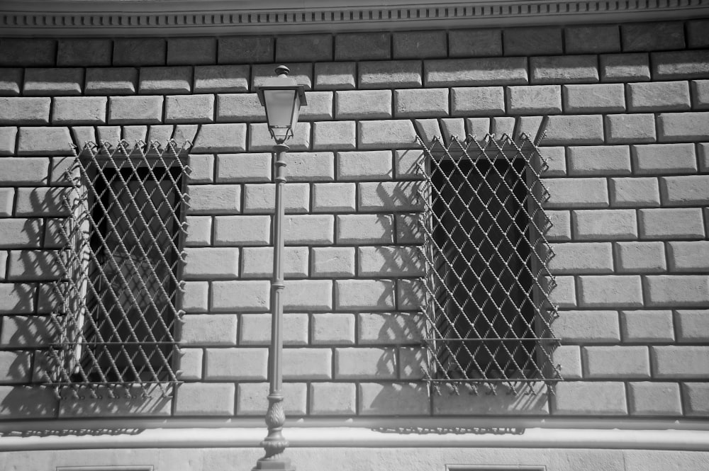 a black and white photo of two windows on a building