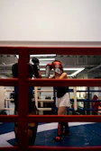 a woman standing in a boxing ring with a punching mitt