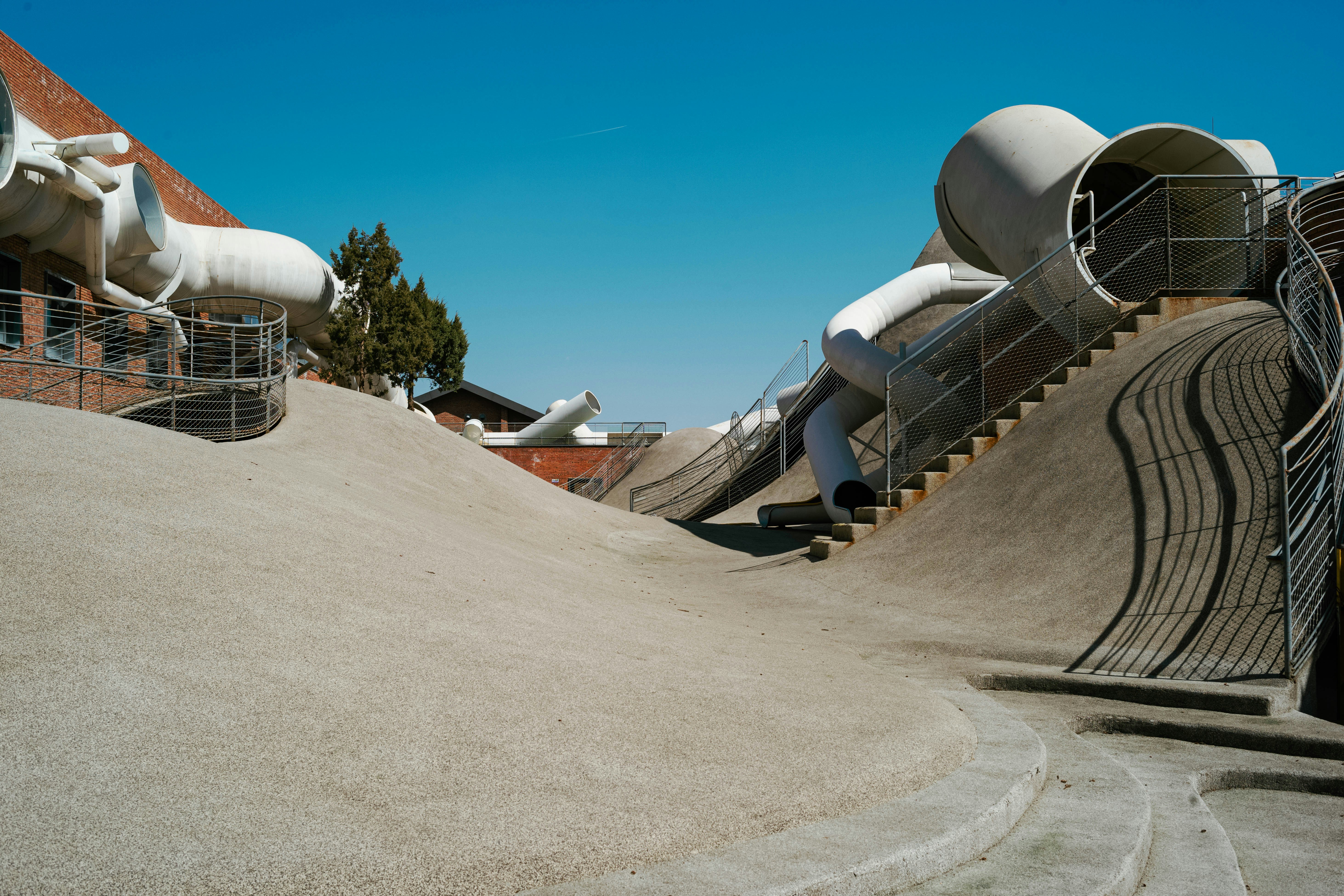 A skateboard park with ramps and slides photo – Free Play area Image on ...