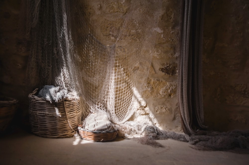 a room with a basket and a blanket on the floor