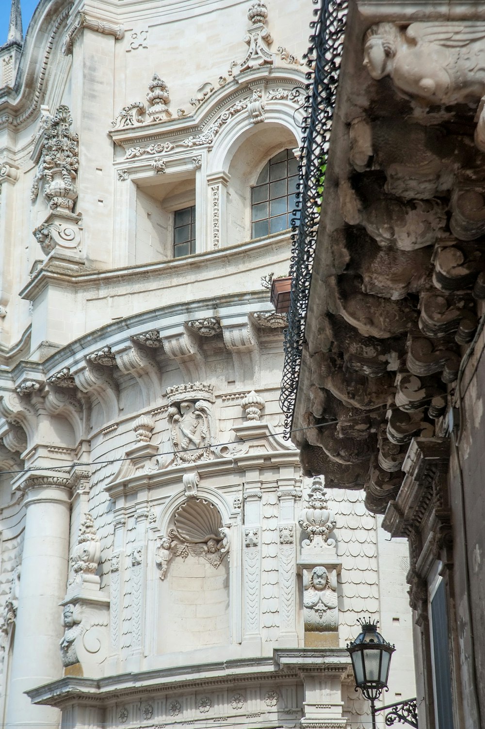 a tall white building with a clock on it's side