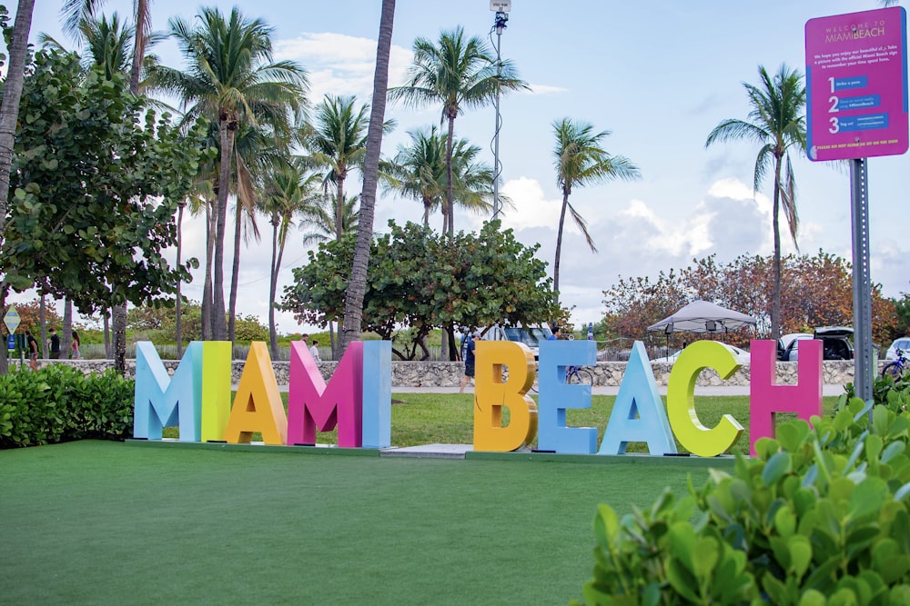 a sign that says miami beach in multicolored letters