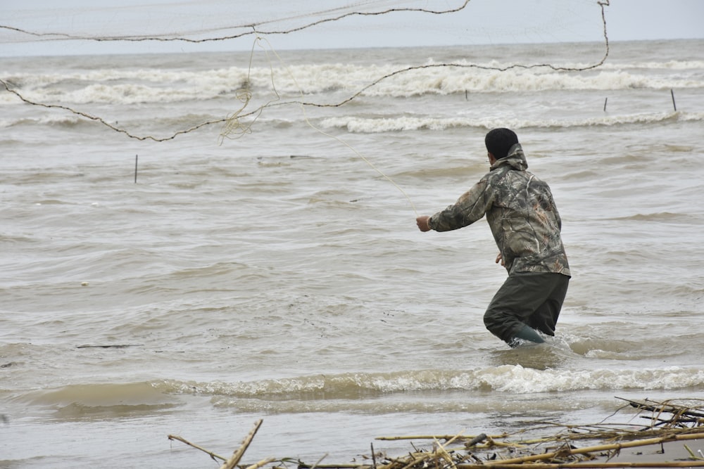 a man is wading through the water in the ocean