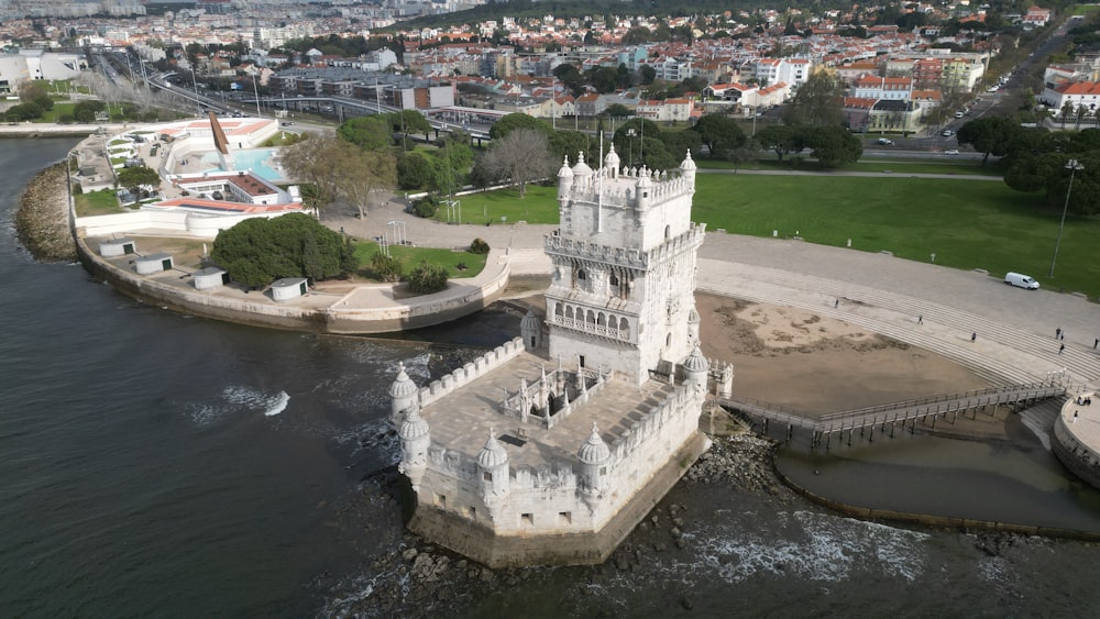 an aerial view of a castle in the middle of a body of water