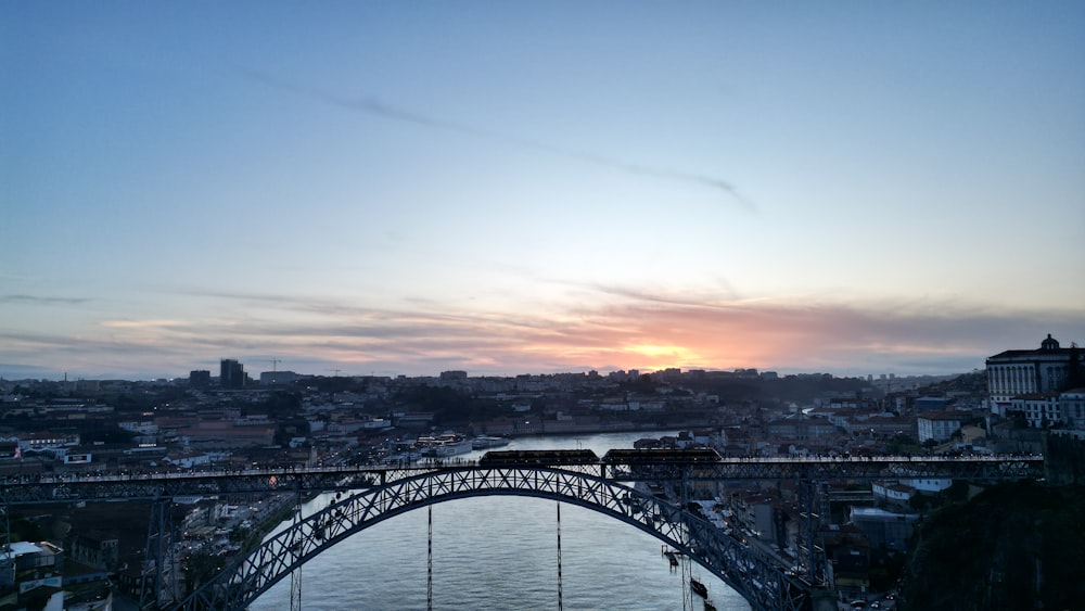 a bridge over a body of water with a train on it