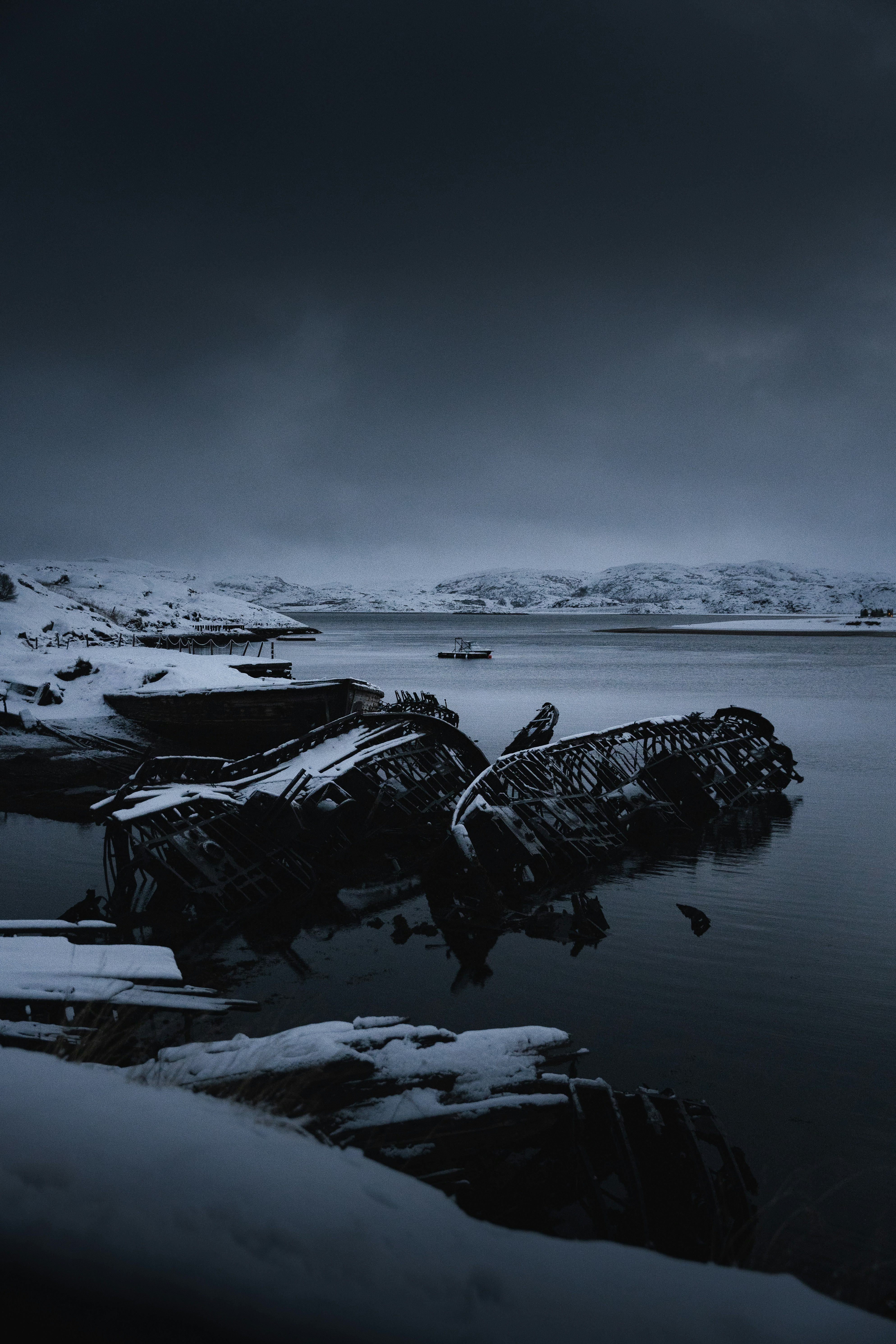 a boat sitting on top of a body of water covered in snow