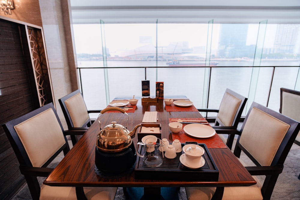 a wooden table with plates and cups on it