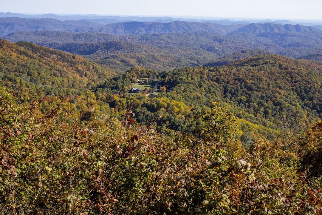 a scenic view of a valley surrounded by mountains,