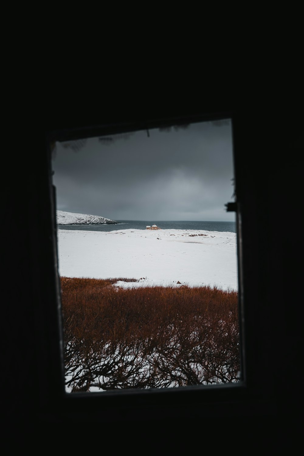 a view of a snowy field from a window