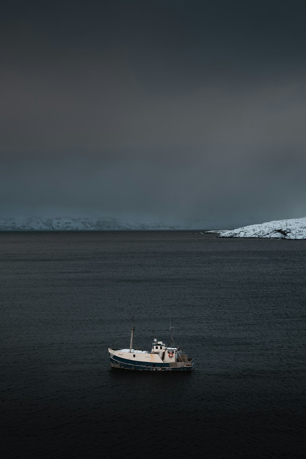 a boat floating on top of a large body of water