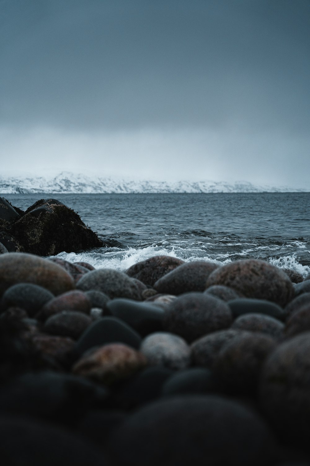 a black and white photo of rocks and water