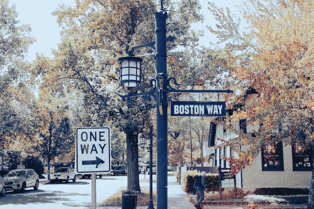 a one way street sign on a street corner