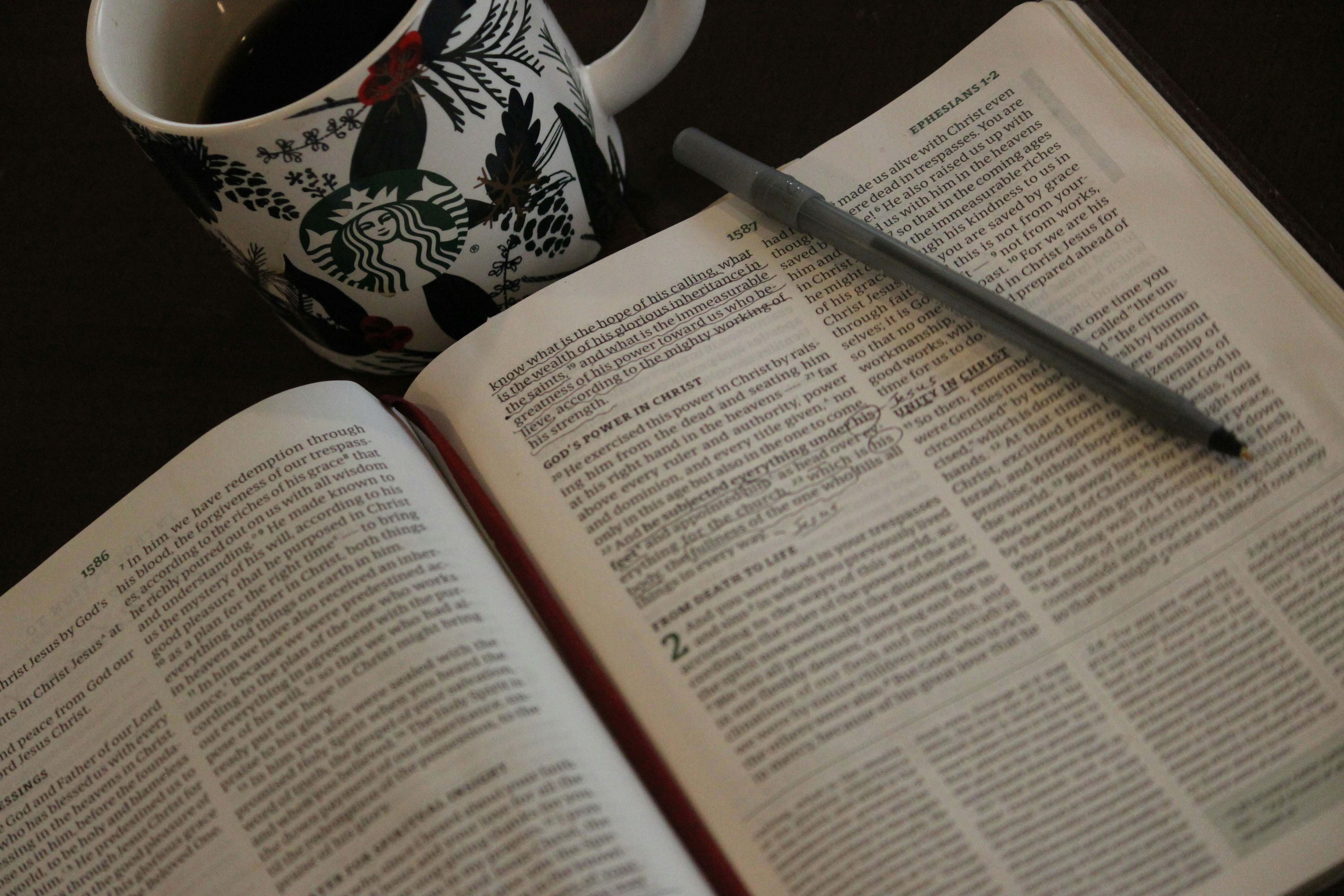 a cup of coffee and a book on a table