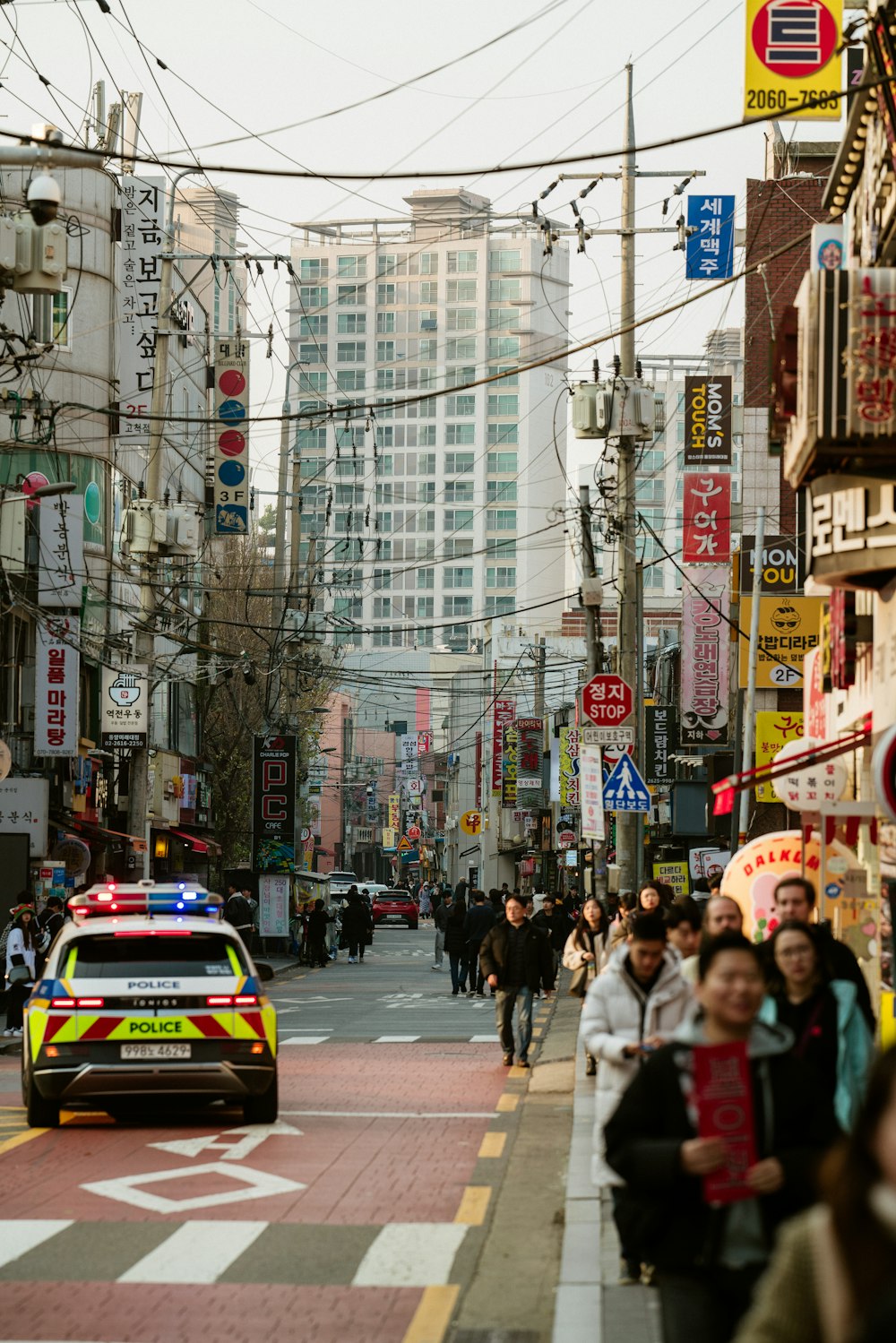 a police car driving down a busy city street