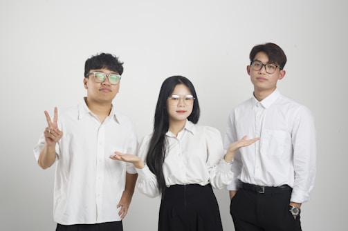 a group of three people standing next to each other